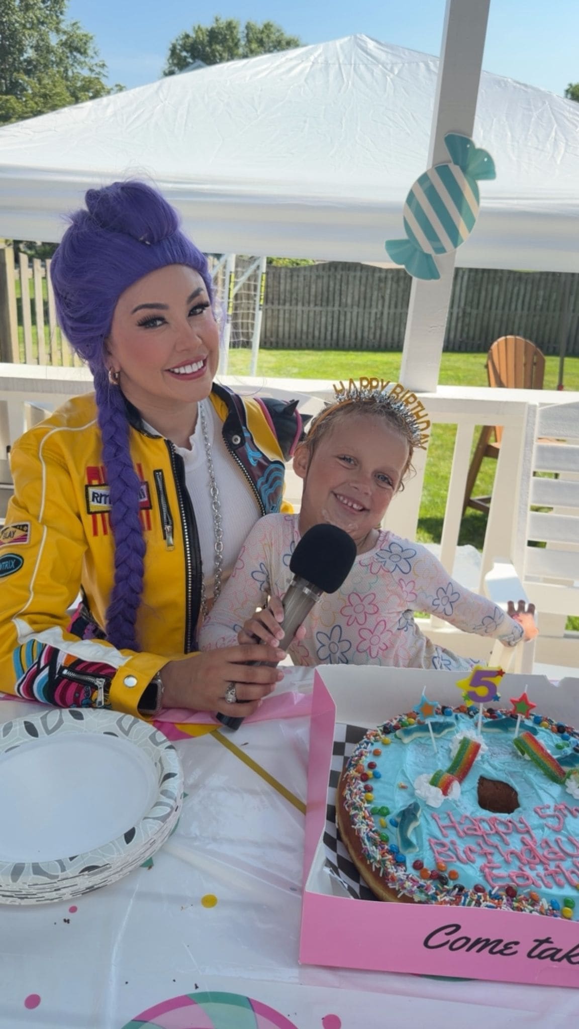 Costumed K-pop Demon Hunters character performer with a child and birthday cake