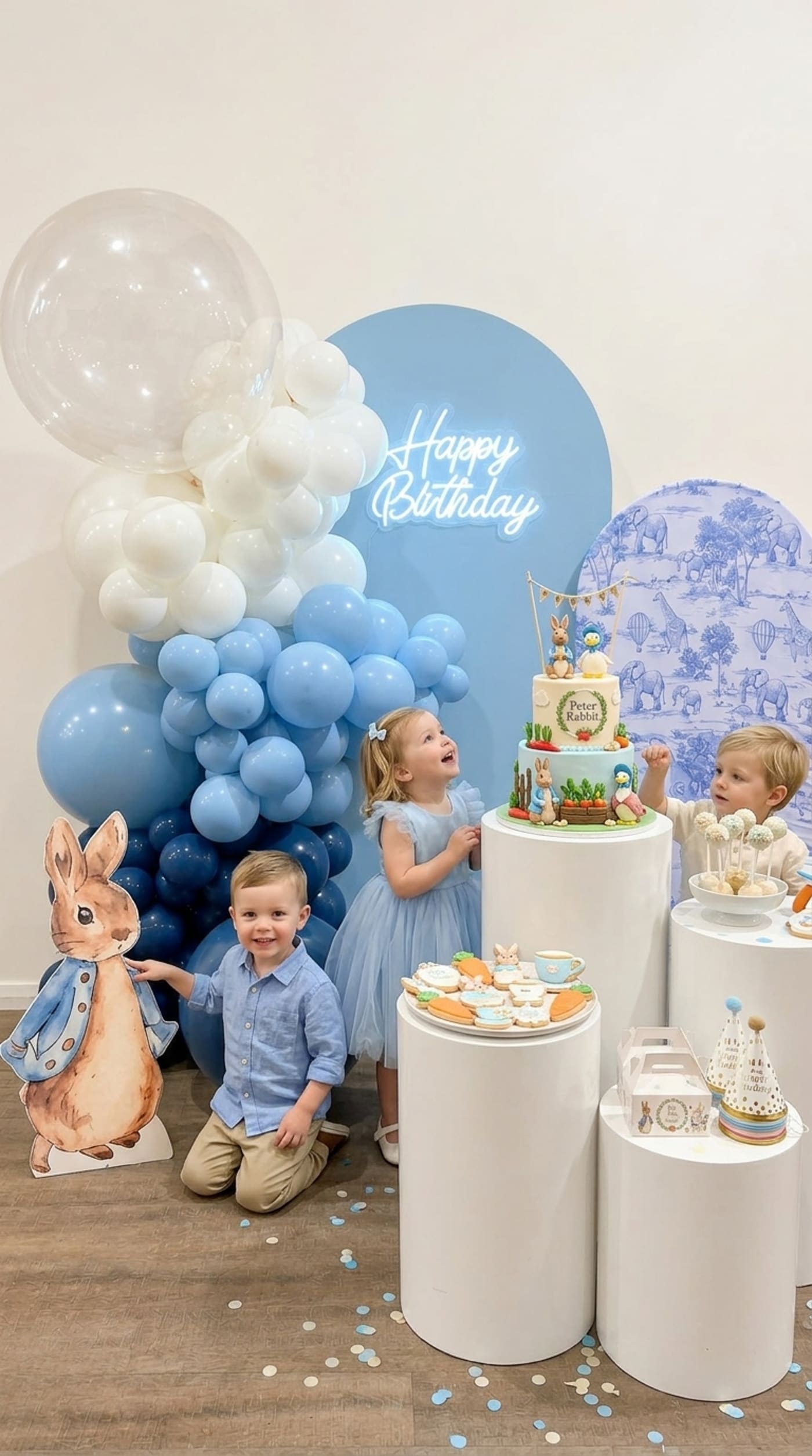 Peter Rabbit themed birthday backdrop with blue balloon garland