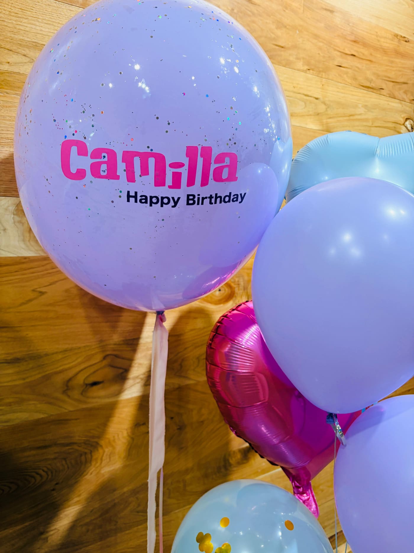 Personalized glitter bubble balloon printed with a name and Happy Birthday message