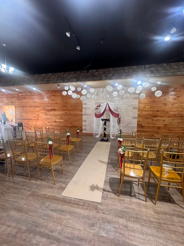 Ceremony aisle and draped arch set up at the Esme venue