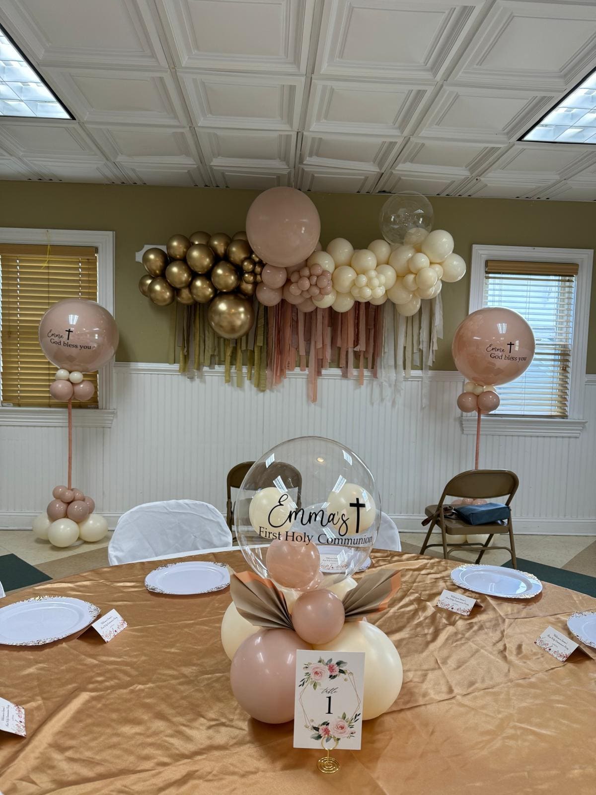 Gold and blush balloon garland setup for a First Communion at Esme
