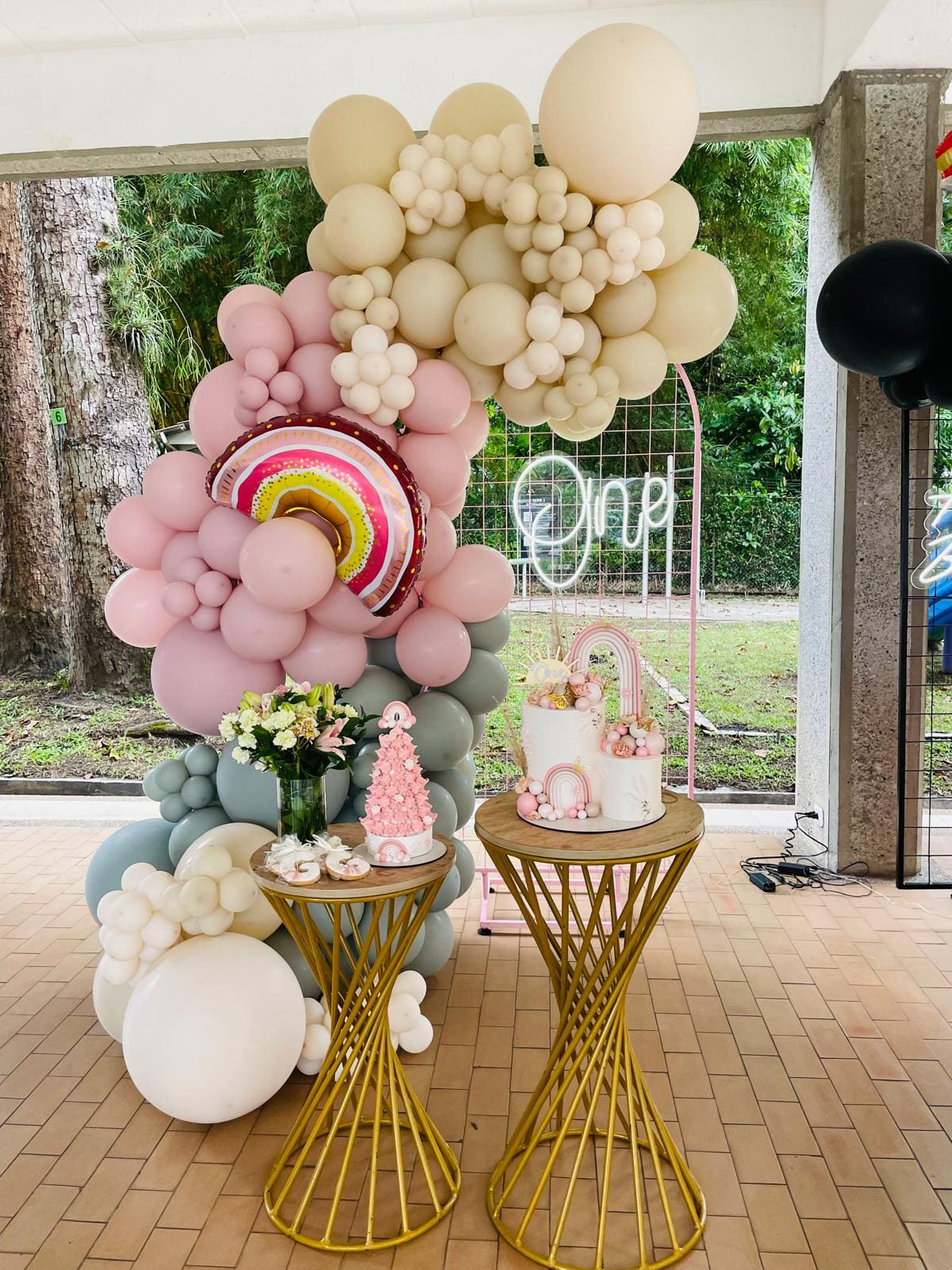 Pink and cream boho first birthday balloon setup by Esme